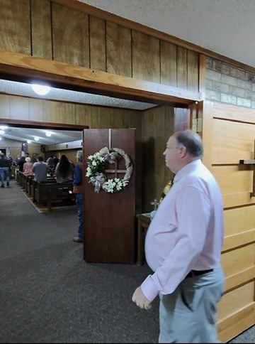 My post at the back of Oak Grove Baptist Church — Pastor Craig Evers walking in